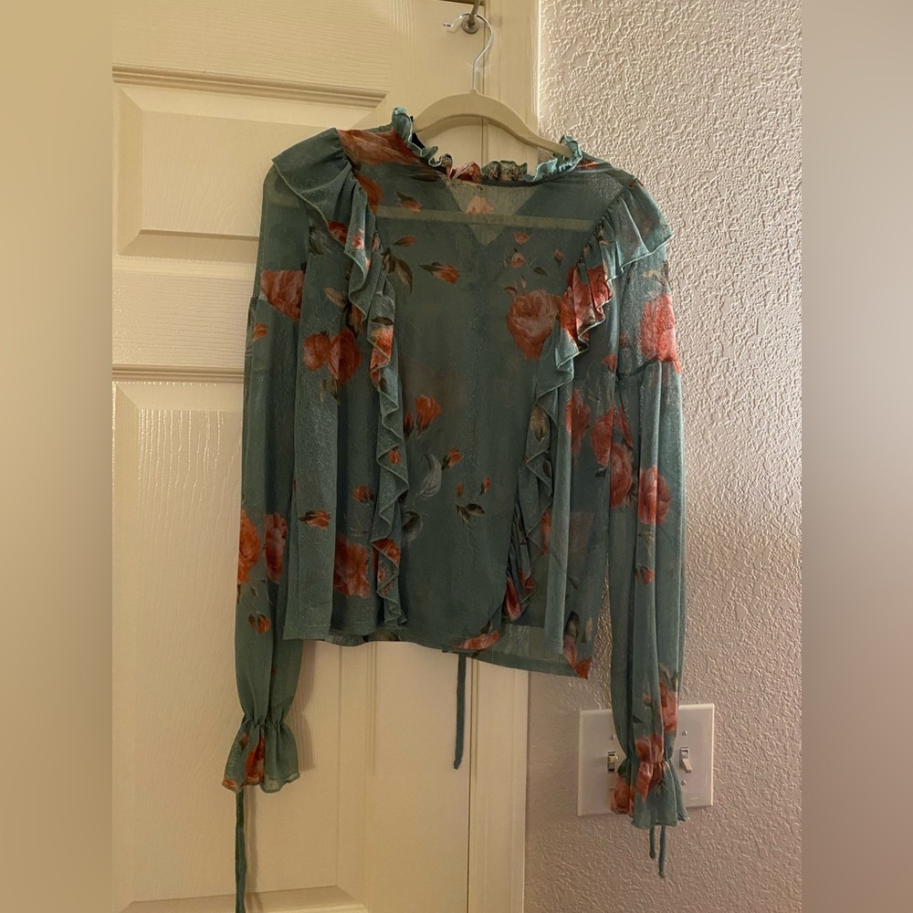 Green ruffled blouse.